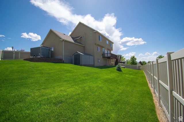 1233 E Upland Dr S Unit 112, Tooele, UT 84074 - rear view of house featuring a fenced backyard, stucco siding, and a shed