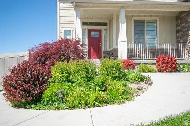 1233 E Upland Dr S Unit 112, Tooele, UT 84074 - property entrance featuring stone siding, covered porch, and board and batten siding