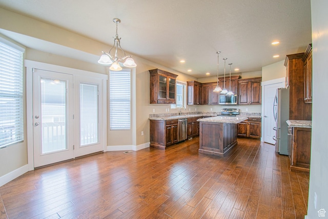 1233 E Upland Dr S Unit 112, Tooele, UT 84074 - kitchen featuring stainless steel appliances, a kitchen island, plenty of natural light, a chandelier, and recessed lighting