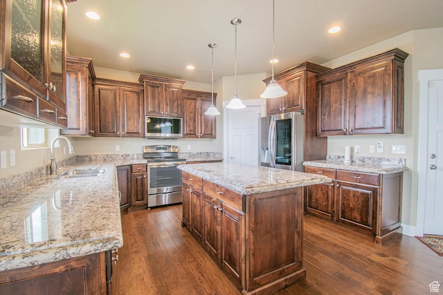 1233 E Upland Dr S Unit 112, Tooele, UT 84074 - kitchen with stainless steel appliances, dark wood-style flooring, light stone countertops, a center island, and recessed lighting