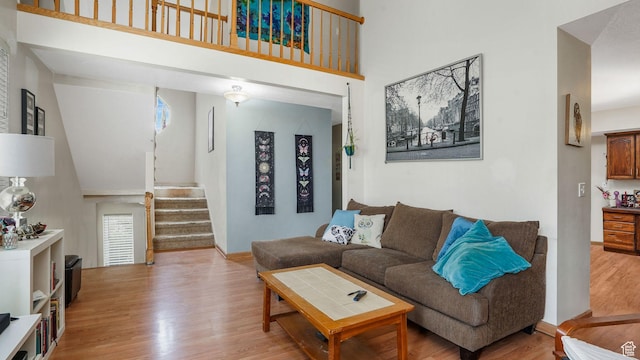 1248 E Freshman Cir, Millcreek, UT 84117 - living room featuring a towering ceiling, wood finished floors, and stairs