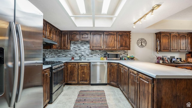 1248 E Freshman Cir, Millcreek, UT 84117 - kitchen with stainless steel appliances, under cabinet range hood, backsplash, a peninsula, and light countertops