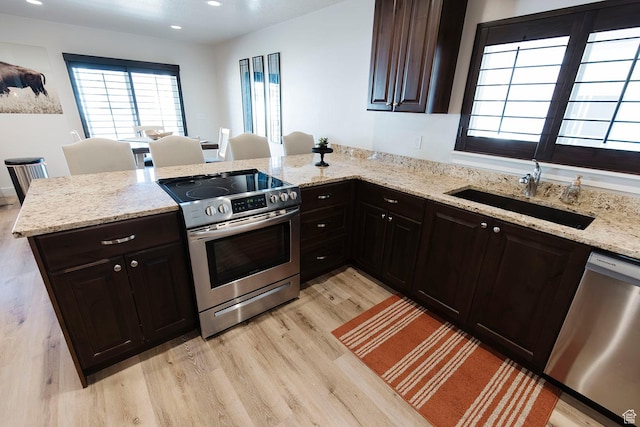 926 N 165 W, Nephi, UT 84648 - kitchen with stainless steel appliances, light wood-style flooring, a peninsula, light stone counters, and recessed lighting