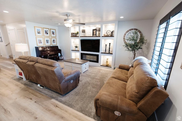 926 N 165 W, Nephi, UT 84648 - living room with recessed lighting, light wood-style floors, a ceiling fan, and a glass covered fireplace