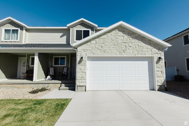 926 N 165 W, Nephi, UT 84648 - view of front of property featuring concrete driveway, covered porch, board and batten siding, stone siding, and an attached garage