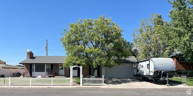 663 E 485 S, Orem, UT 84097 - view of front of house featuring an attached garage, a fenced front yard, brick siding, and concrete driveway
