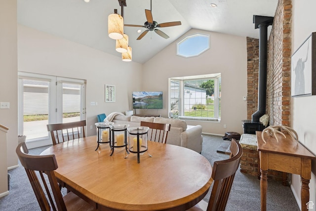 145 S 300 E, Kaysville, UT 84037 - carpeted dining room with a wood stove, a ceiling fan, plenty of natural light, and high vaulted ceiling