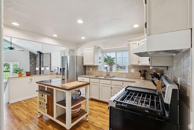145 S 300 E, Kaysville, UT 84037 - kitchen with stainless steel appliances, plenty of natural light, decorative backsplash, white cabinets, and recessed lighting
