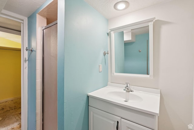 145 S 300 E, Kaysville, UT 84037 - full bath featuring vanity, a shower stall, a spacious closet, and a textured ceiling