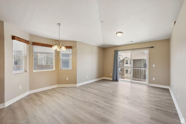 8229 S Resaca Dr Unit D11, Sandy, UT 84070 - empty room with light wood finished floors, a chandelier, and a textured ceiling