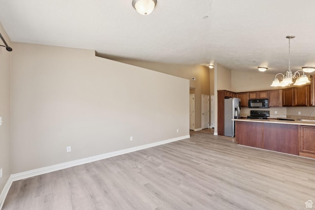 8229 S Resaca Dr Unit D11, Sandy, UT 84070 - kitchen with black appliances, brown cabinetry, open floor plan, lofted ceiling, and light countertops