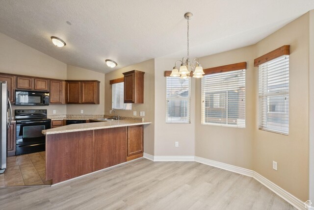 8229 S Resaca Dr Unit D11, Sandy, UT 84070 - kitchen featuring black appliances, light wood-style flooring, light countertops, a chandelier, and a peninsula
