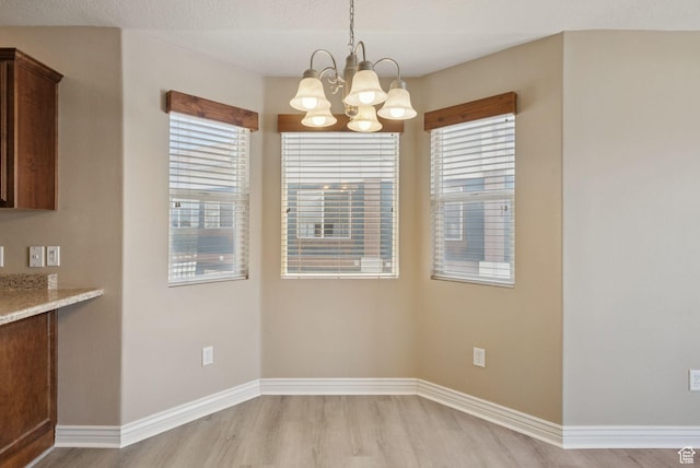 8229 S Resaca Dr Unit D11, Sandy, UT 84070 - unfurnished dining area with wood finished floors and a chandelier
