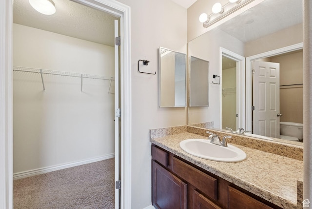 8229 S Resaca Dr Unit D11, Sandy, UT 84070 - bathroom featuring vanity and a walk in closet