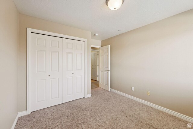 8229 S Resaca Dr Unit D11, Sandy, UT 84070 - unfurnished bedroom with carpet flooring and a closet