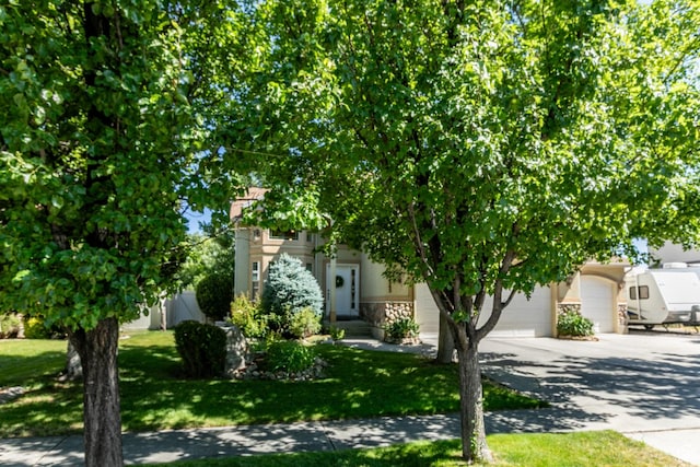 2343 E 1580 S, Spanish Fork, UT 84660 - obstructed view of property featuring driveway, a garage, a front lawn, and stone siding