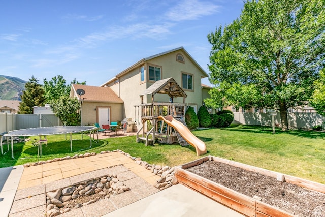 2343 E 1580 S, Spanish Fork, UT 84660 - view of play area with a trampoline, a fenced backyard, and a patio