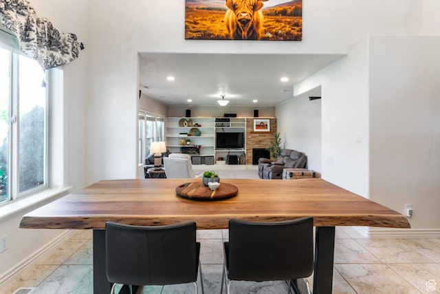 2343 E 1580 S, Spanish Fork, UT 84660 - dining room with light marble finish floors and a fireplace
