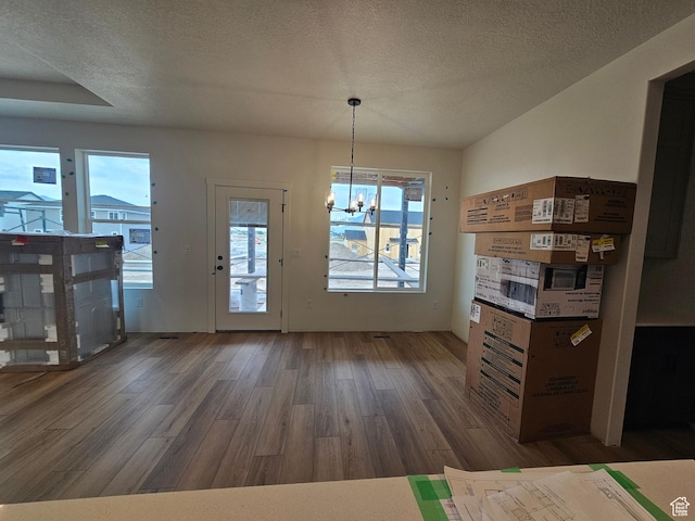 1768 S 3875 W Unit 227, Taylor, UT 84401 - unfurnished dining area featuring wood finished floors, a chandelier, and a textured ceiling