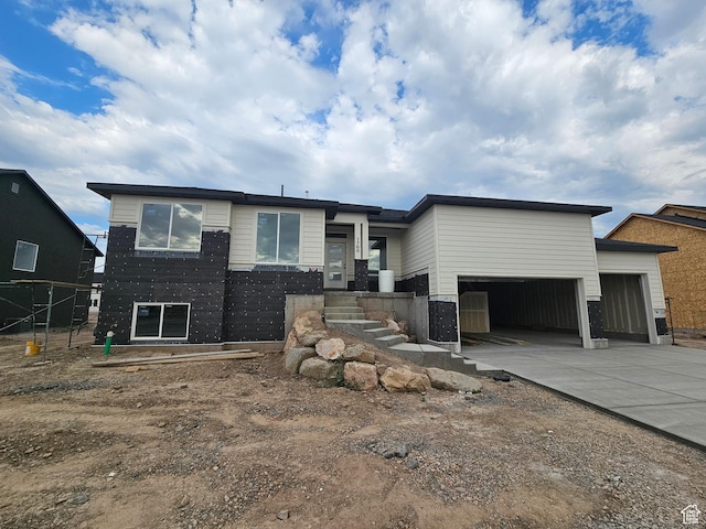 1768 S 3875 W Unit 227, Taylor, UT 84401 - view of front of house featuring a garage and concrete driveway