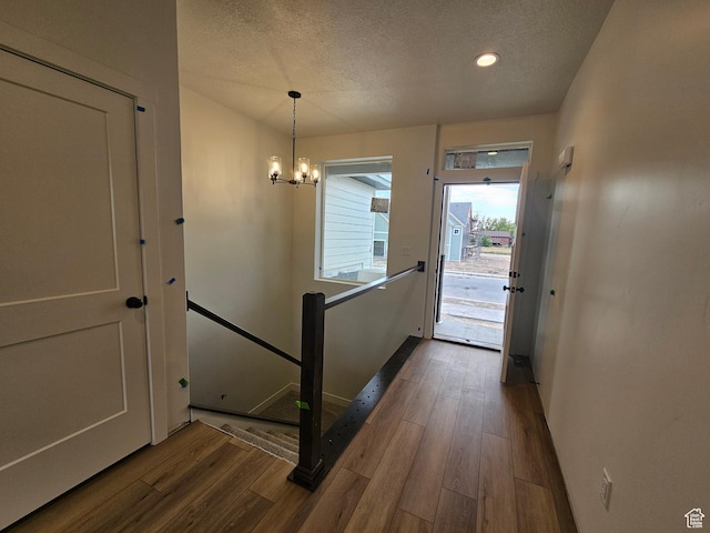 1768 S 3875 W Unit 227, Taylor, UT 84401 - entryway with wood finished floors, a textured ceiling, a chandelier, and recessed lighting