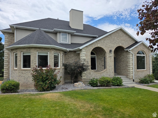107 W High Sierra Dr, Elk Ridge, UT 84651 - view of front of home featuring a front lawn, a chimney, and a shingled roof