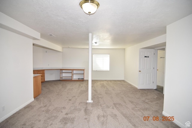 107 W High Sierra Dr, Elk Ridge, UT 84651 - below grade area with light colored carpet, a textured ceiling, and built in study area