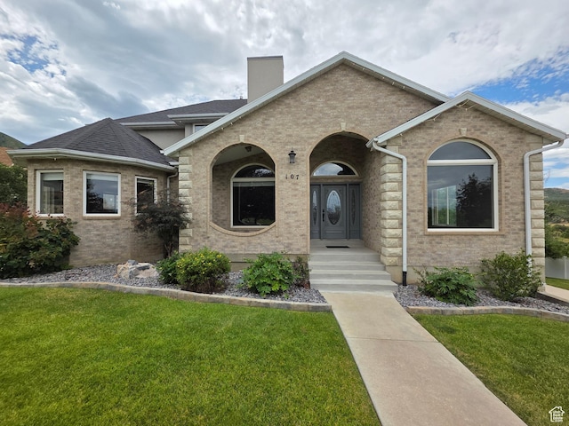 107 W High Sierra Dr, Elk Ridge, UT 84651 - view of front of property with a front yard, a chimney, and brick siding