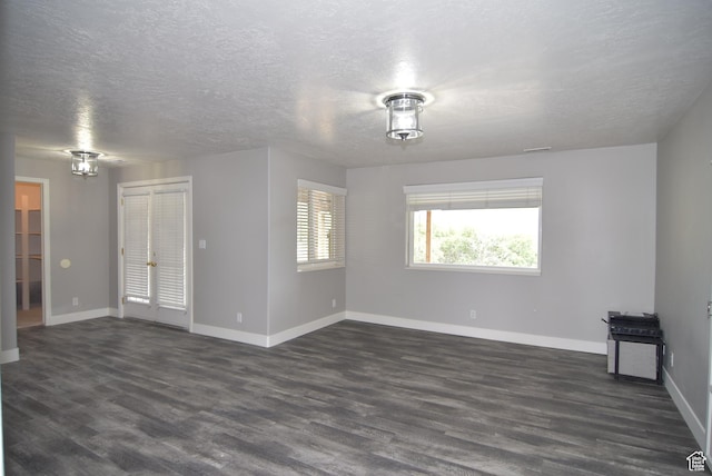 107 W High Sierra Dr, Elk Ridge, UT 84651 - unfurnished room featuring dark wood-type flooring and a textured ceiling