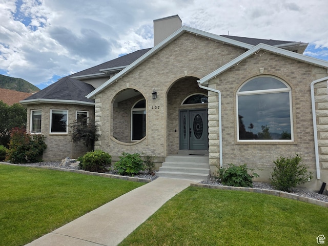 107 W High Sierra Dr, Elk Ridge, UT 84651 - view of front facade with a front lawn, brick siding, and a chimney