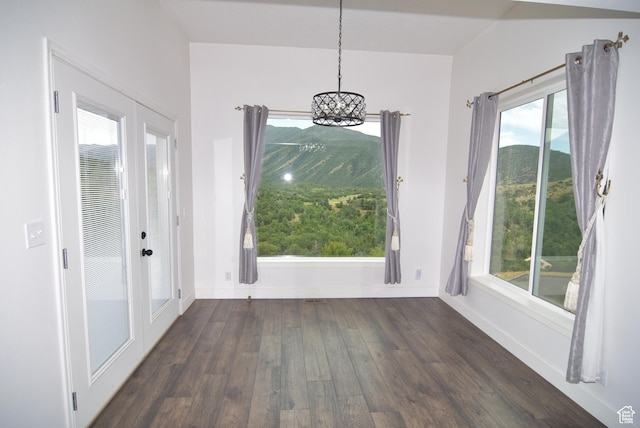107 W High Sierra Dr, Elk Ridge, UT 84651 - unfurnished dining area with a chandelier, wood finished floors, and healthy amount of natural light