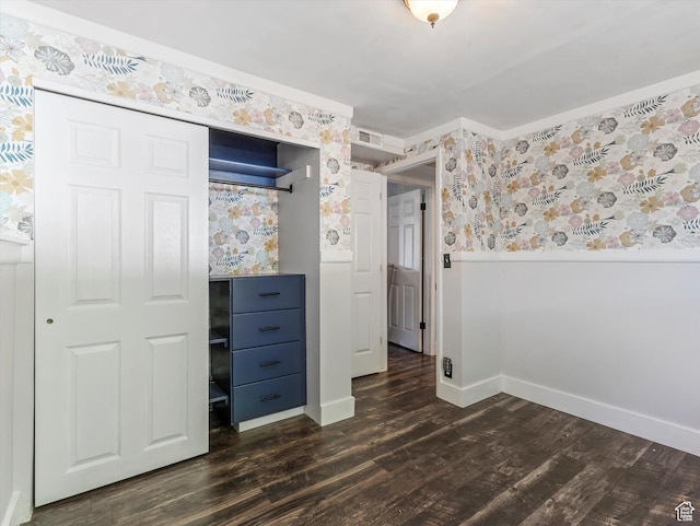 9457 S Poppy Ln, Sandy, UT 84094 - unfurnished bedroom with wallpapered walls, dark wood-type flooring, and a closet