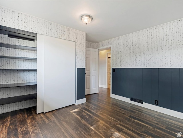 9457 S Poppy Ln, Sandy, UT 84094 - unfurnished bedroom with wainscoting, dark wood finished floors, and wallpapered walls