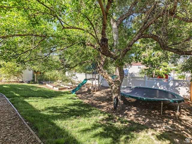 9457 S Poppy Ln, Sandy, UT 84094 - fenced backyard with a trampoline and a vegetable garden