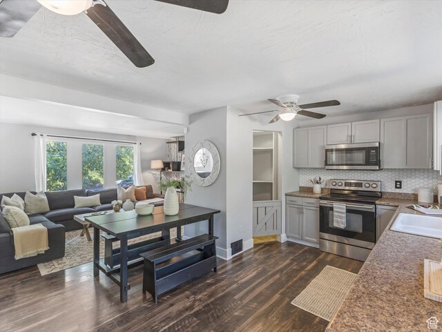 9457 S Poppy Ln, Sandy, UT 84094 - kitchen featuring stainless steel appliances, a ceiling fan, dark wood-style floors, open floor plan, and decorative backsplash
