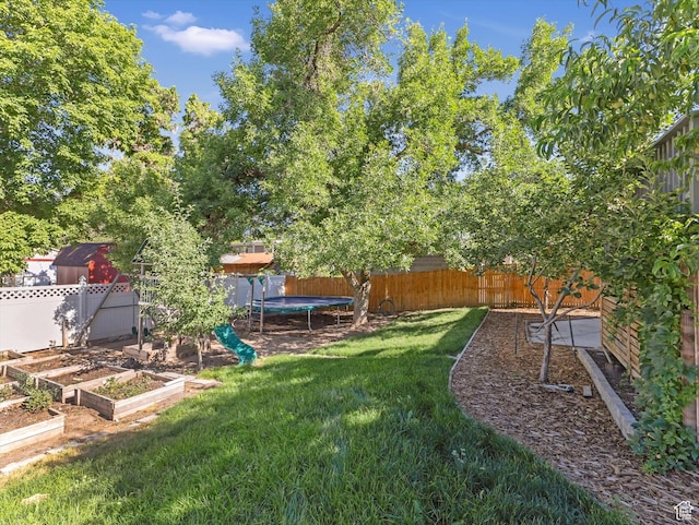 9457 S Poppy Ln, Sandy, UT 84094 - fenced backyard with a trampoline and a vegetable garden