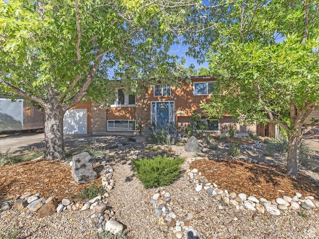9457 S Poppy Ln, Sandy, UT 84094 - view of front of house featuring brick siding, concrete driveway, and a garage