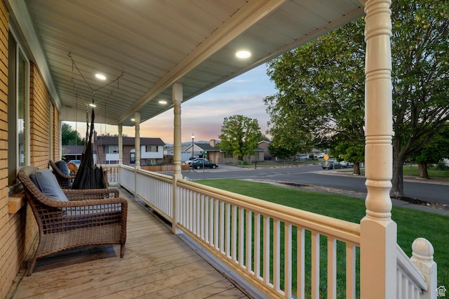 3558 S Chippewa Rd, West Valley City, UT 84120 - porch featuring a residential view and a yard