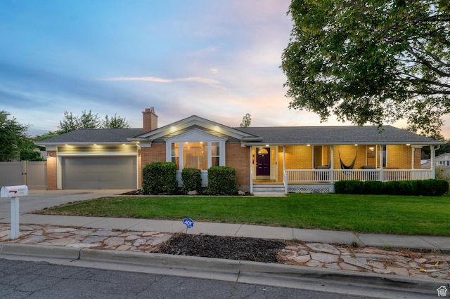 3558 S Chippewa Rd, West Valley City, UT 84120 - single story home with brick siding, a porch, concrete driveway, and an attached garage