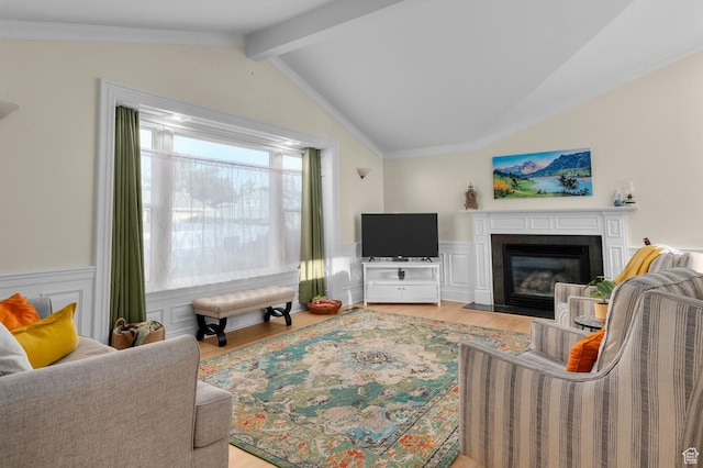 3558 S Chippewa Rd, West Valley City, UT 84120 - living area with lofted ceiling, light wood finished floors, a wainscoted wall, a fireplace with flush hearth, and ornamental molding