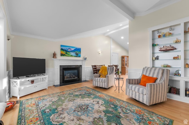 3558 S Chippewa Rd, West Valley City, UT 84120 - living area with wood finished floors, a glass covered fireplace, ornamental molding, and recessed lighting