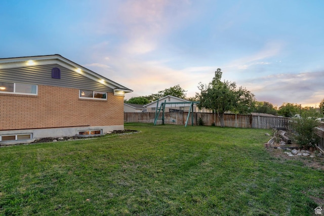 3558 S Chippewa Rd, West Valley City, UT 84120 - yard at dusk featuring a playground and a fenced backyard