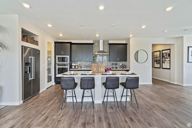6181 W Franciscotti Dr Unit 521, South Jordan, UT 84009 - kitchen with stainless steel appliances, wood finished floors, a center island, backsplash, and recessed lighting