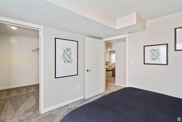 6181 W Franciscotti Dr Unit 521, South Jordan, UT 84009 - bedroom featuring carpet flooring, a spacious closet, and a textured ceiling
