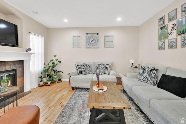 861 E Red Sage Ln, Murray, UT 84107 - living area with wood finished floors, a tiled fireplace, and recessed lighting