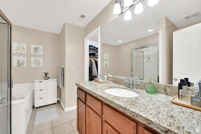 861 E Red Sage Ln, Murray, UT 84107 - full bathroom with vanity, a shower stall, a garden tub, tile patterned flooring, and a spacious closet