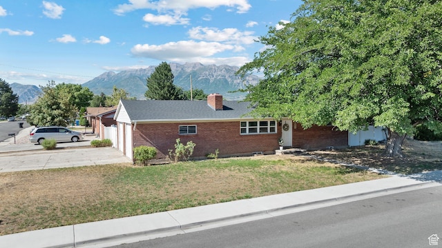 251 E 1500 S, Orem, UT 84058 - ranch-style home with brick siding, a mountain view, a chimney, and an attached garage