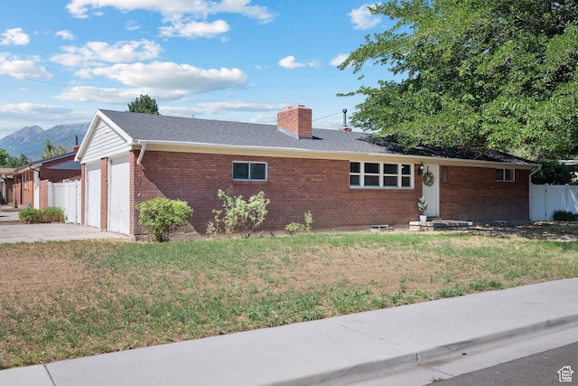 251 E 1500 S, Orem, UT 84058 - single story home featuring brick siding, a chimney, a mountain view, and an attached garage
