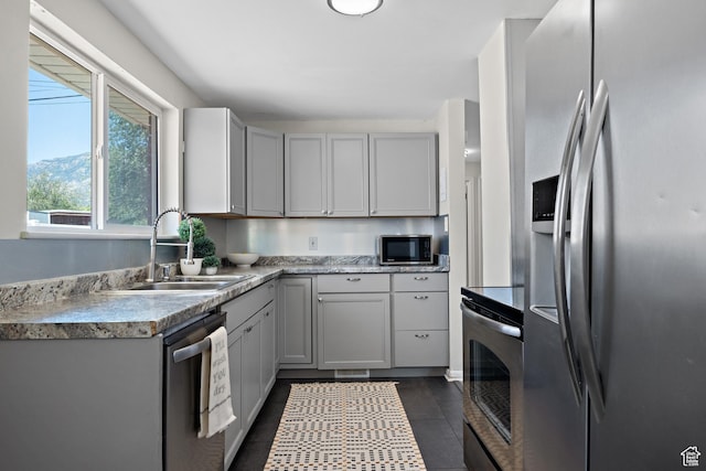 251 E 1500 S, Orem, UT 84058 - kitchen featuring stainless steel appliances, light countertops, dark tile patterned floors, and gray cabinets