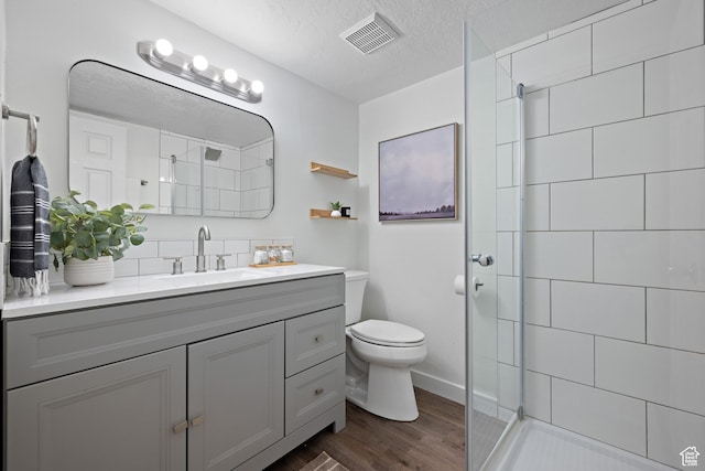 251 E 1500 S, Orem, UT 84058 - full bath with vanity, tiled shower, wood finished floors, tasteful backsplash, and a textured ceiling
